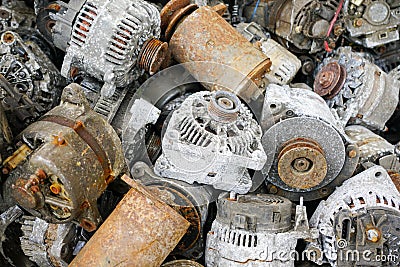 A pile of used car starters and generators, scrap electric motors Stock Photo