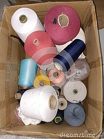 A pile of various threads in a cardboard box Stock Photo