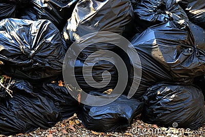 Pile waste plastic bags many garbage trash closeup for background, pile of garbage plastic black, pollution trash plastic waste an Stock Photo