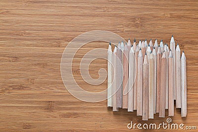 Pile of wooden pencils lying on the desk. Background for office themes. Stock Photo