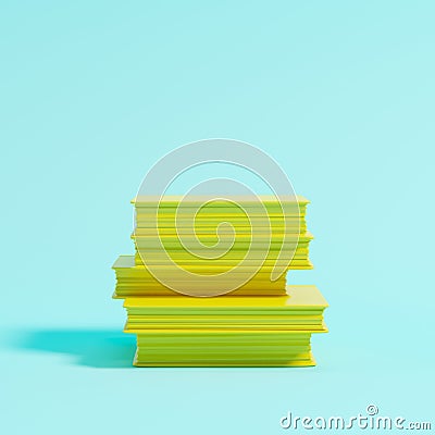 Pile of yellow books on blue background for copy space Stock Photo