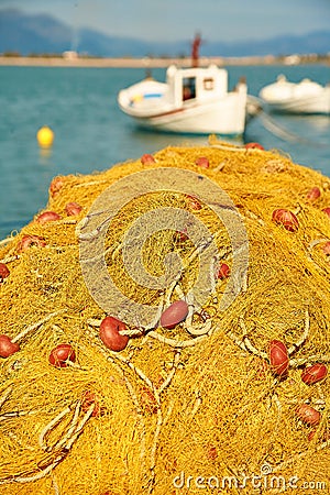 Pile of yellow fishing nets in port Stock Photo