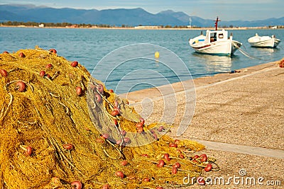 Pile of yellow fishing nets in port Stock Photo