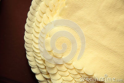 Pile of yellow paper napkin on table Stock Photo