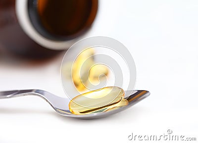 Pile of yellow softgel pills closeup on white background.Healthy nutrition and lifestyle concept. Nutraceuticals with omega3 poly Stock Photo