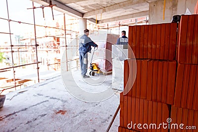 Piled resources of red blocks, packed in background Editorial Stock Photo