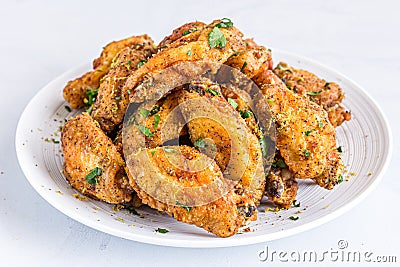 Piled Up Fried Chicken Wings on a White Plate Stock Photo