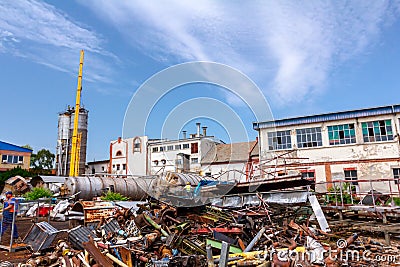 Pile rusted cut parts of obsolete equipment in industrial complex Stock Photo