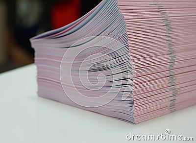 Piles of handout papers placed on table Stock Photo