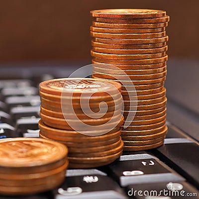 Piles of Japanese 10 yen coins are on the black keyboard of a computer or laptop. Illustration: online trading, payments and Stock Photo