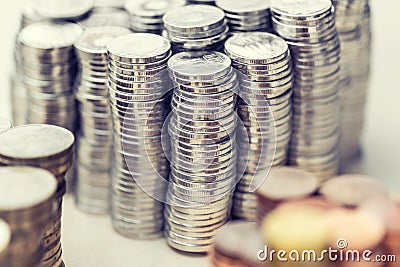 Piles of metalic different currencies in different colors Stock Photo