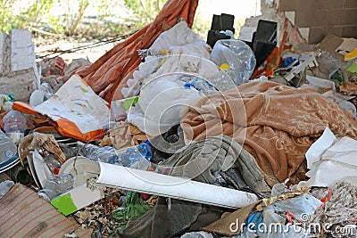Piles of rubbish and rags in an homeless camp after the forced e Stock Photo