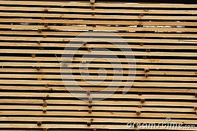 Piles of wooden boards in the sawmill, planking. Warehouse for sawing boards on a sawmill outdoors. Wood timber stack of Stock Photo