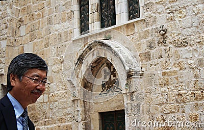 Pilgrim in the main entrance of the Church of the Holy Sepulchre, Israel, Jerusalem Editorial Stock Photo
