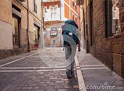 Pilgrim walking in Pamplona's street along the Way to Santiago de Compostela Editorial Stock Photo
