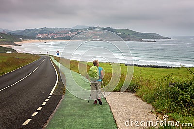 Pilgrim walking towards San Vicente de la Barquera, Cantabria, S Stock Photo