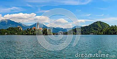 The Pilgrimage Church of the Assumption of Mary on the island of Lake Bled is a symbol of Slovenia on a background of alpine Stock Photo