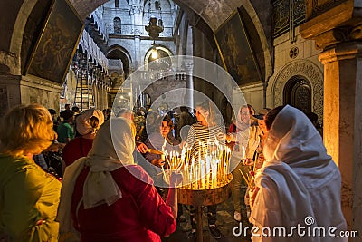 The pilgrims lit candles, Church of the Holy Sepulchre in Jerusalem, Israel. Editorial Stock Photo