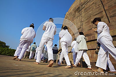 Pilgrims praying at the Buddhist Stupa Editorial Stock Photo