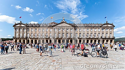 Pilgrims and tourists in the Plaza del Obradoiro. The Plaza del Obradoiro is the largest of its kind in the whole of Galicia Editorial Stock Photo