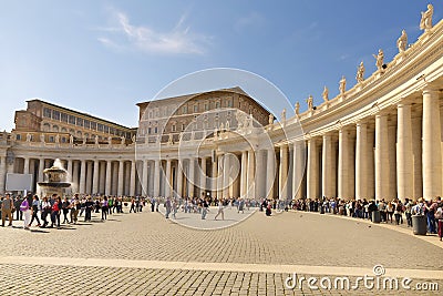 Pilgrims and tourists queue under colomnade waiting to enter in St Peter basilica Editorial Stock Photo