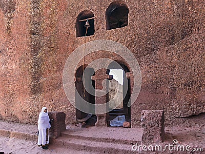 Piligrim near lalibela church bell tower stone wall Editorial Stock Photo