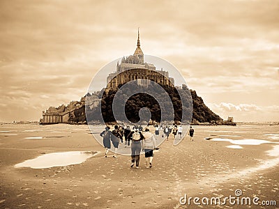 Piligrims walking to Mont Saint Michel Editorial Stock Photo