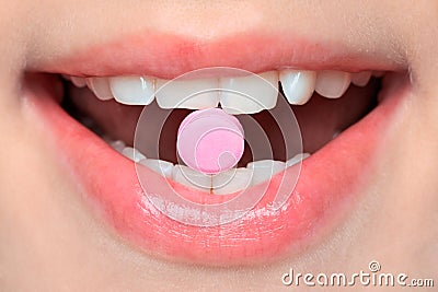 Pill in mouth Stock Photo