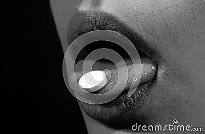 Pill and the mouth, isolated on black background. Close up woman with pills supplement. Vitamins, natural beauty Stock Photo