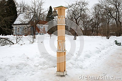 A pillar with a bell to call for dinner Editorial Stock Photo