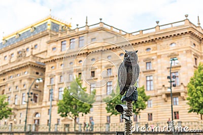 A pillar with a CCTV camera decorated with an owl sculpture. Against the background of the city. Surveillance concept Stock Photo