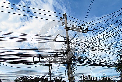 Pillar with lots of wires. Thailand, beautiful blue sky Stock Photo