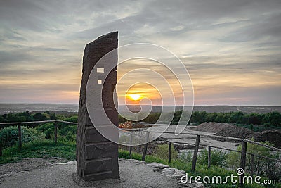 Pillar on top of hill at sunset Stock Photo