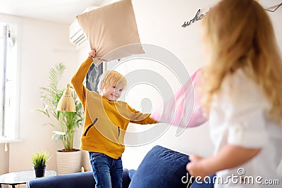 Pillow fight. Brother and sister play together. Active games for siblings at home Stock Photo