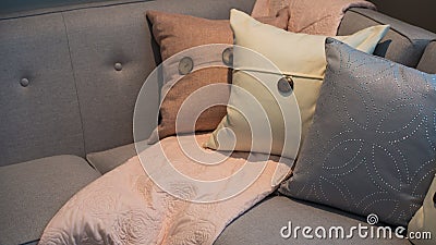 Pillows on a grey modern corner sofa Stock Photo