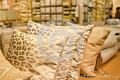 Pillows warm pastel colors in soft light on the sofa in the store. Background Stock Photo