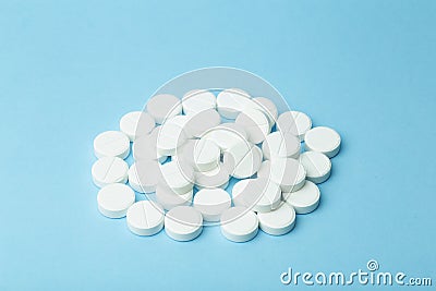 Pills background. Pills, drags and medecine concept. White tablets on a blue background Stock Photo