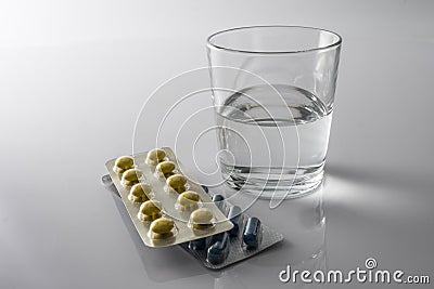 Pills Blister along with a water glass Stock Photo