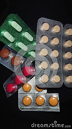 Pills and capsules of different shapes and colors Stock Photo