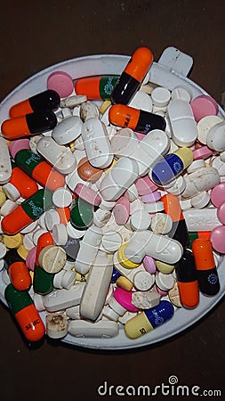 Pills and capsules of different shapes and colors Stock Photo