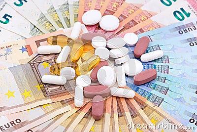 Pills and capsules on money Stock Photo