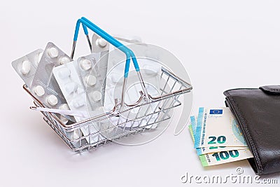 Pills and Capsules in a Shopping Basket and Black Wallet with Euro Money Stock Photo