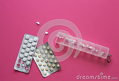 Pills in container near blisters in shape of heart on pink background. Necessary dose for treating disease. Concept for Stock Photo