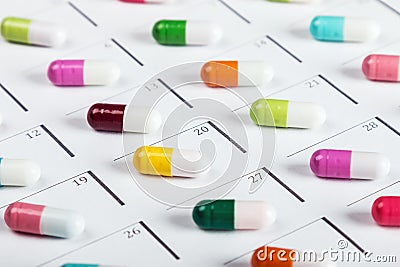 Pills are of different color on the calendar Stock Photo