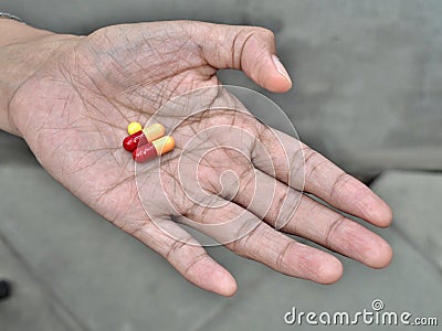 Pills on elder hand Stock Photo