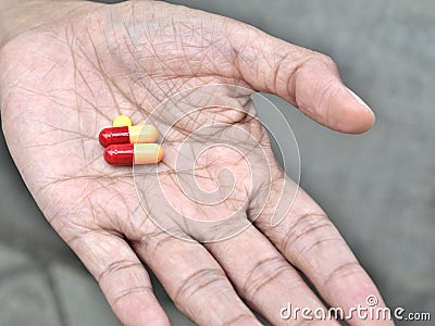 Pills on elder hand Stock Photo