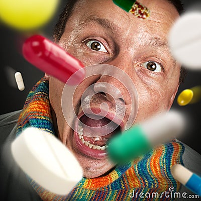 Pills falling into open mouth Stock Photo