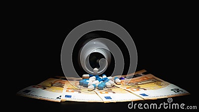 Pills Falling Out of bottle on euro bills. Medical Cost Concept. Stock Photo