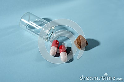 Pills in a glass jar on a light background close-up. medical preparations. vitamins. empty pill jars. chemical production Stock Photo