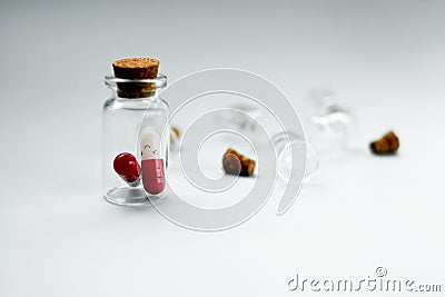 Pills in a glass jar on a light background close-up. medical preparations. vitamins. empty pill jars. chemical production Stock Photo
